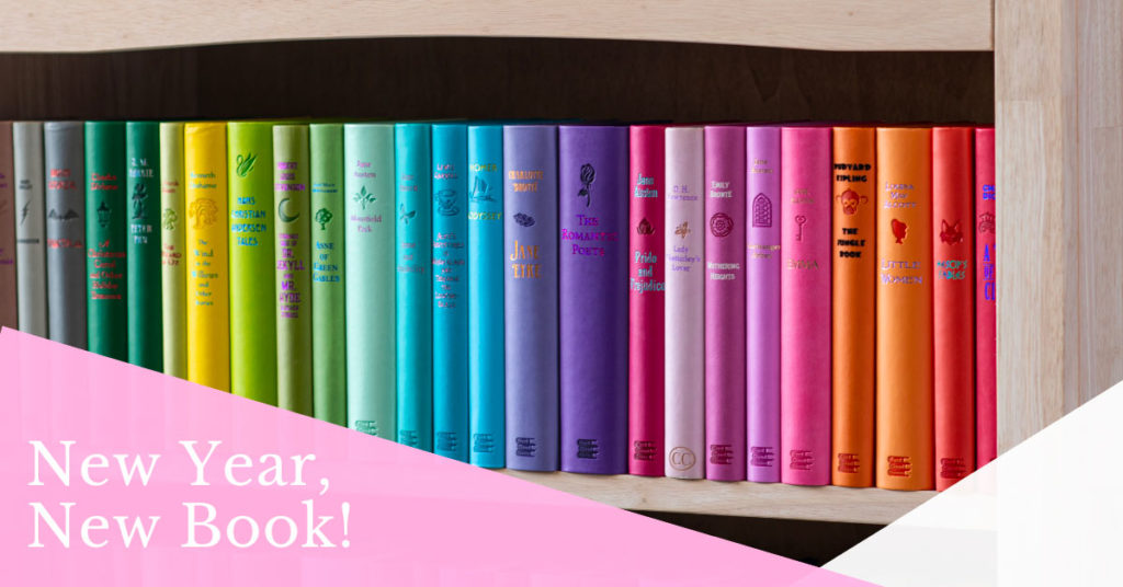 New Year, New Books! Multicolored books sit on a shelf